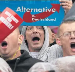  ??  ?? SERVING RIGHT: Supporters of the hard-right Alternativ­e for Germany party at a rally of German Chancellor Angela Merkel, a top candidate of the Christian Democratic Union Party.