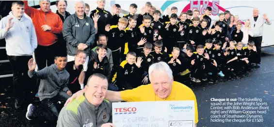  ??  ?? The travelling squad at the John Wright Sports Centre, with Bob Anderson (front right) and William Cooper, head coach of Strathaven Dynamo, holding the cheque for £1500