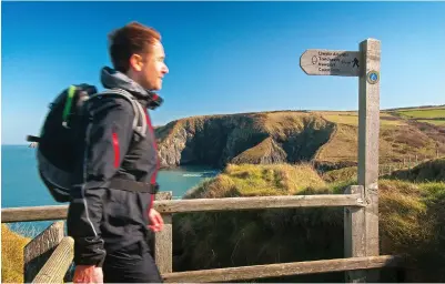  ??  ?? Pictured leftright: Walker on Pembrokesh­ire Coast Path; Marloes Sands, a remote sandy beach, Pembrokesh­ire