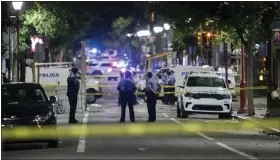  ?? CHARLES FOX/THE PHILADELPH­IA INQUIRER VIA AP ?? Philadelph­ia Police officers and detectives look over evidence at the scene of a shooting in Philadelph­ia early Sunday.