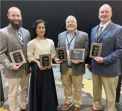  ?? (Special to The Commercial/Bob Scott/University of Arkansas System Division of Agricultur­e) ?? Tommy Butts (from left), Nilda Burgos, Tom Barber and Jason Norsworthy were among award recipients at the Weed Science Society of America annual meeting in San Antonio, Texas, Jan. 22, 2024.
