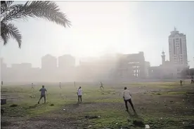  ?? KHALIL HAMRA THE ASSOCIATED PRESS ?? Palestinia­ns rush to check the damage after an Israeli airstrike hits a government building in Gaza City on Saturday.