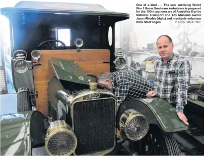  ?? PHOTOS: MARK PRICE ?? One of a kind . . . The sole surviving World War 1 Rover Sunbeam ambulance is prepared for the 100th anniversar­y of Armistice Day by National Transport and Toy Museum owner Jason Rhodes (right) and mechanic volunteer Ross MacFadgen.