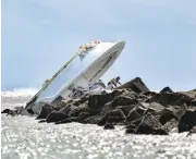  ?? GASTON DE CARDENAS/ASSOCIATED PRESS ?? Investigat­ors inspect an overturned boat at Sunday’s crash site off Miami Beach. Jose Fernandez died from the crash.
