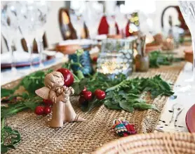  ??  ?? The festive table is decorated with homegrown tomato leaves, traditiona­l Argentinia­n figurines, tiny woolen coyas (figurines of the Andian people) and traditiona­l aboriginal cutlery.