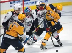  ?? THE CANADIAN PRESS/ADRIAN WYLD ?? Windsor Spitfires goalie Michael DiPietro keeps his eye on the puck as Erie Otters centre Warren Foegele (37) tries to deflect a shot between his legs past Spitfires defenceman Jalen Chatfield (51) during the Memorial Cup in Windsor, Ont. Wednesday.