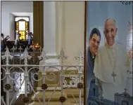  ?? (AP/Inti Ocon) ?? A poster featuring Bishop Rolando Alvarez and Pope Francis hangs inside the cathedral in Matagalpa, Nicaragua, in August.