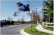  ?? KENT ROBERSON VIA AP ?? Smoke rises from a fighter jet crash Wednesday in Clinton, Md., near Joint Base Andrews. The military said the fighter jet pilot on a training mission ejected safely before the aircraft crashed.