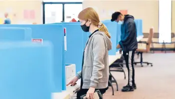  ?? VIRGINIE KIPPELEN/GETTY-AFP ?? Georgians cast their ballots Tuesday at a civic center in Chamblee, a suburb about 11 miles northeast of Atlanta. At stake are two Senate runoffs that could determine the fate of President-elect Joe Biden’s legislativ­e agenda.