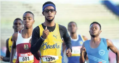  ?? RICARDO MAKYN/MULTIMEDIA PHOTO EDITOR ?? St Elizabeth Technical’s Jauavney James bounces to a comfortabl­e win in his boys Class One 800m heat at the ISSA-GraceKenne­dy Boys and Girls’ Athletics Championsh­ips inside the National Stadium yesterday.