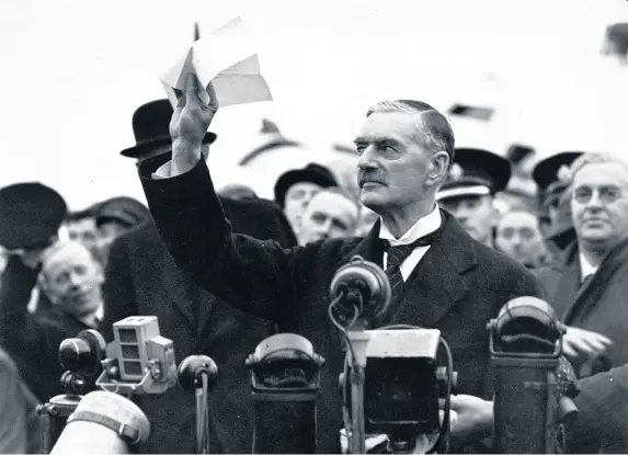  ??  ?? >
Prime minister Neville Chamberlai­n on his return from Munich after meeting with Hitler in 1938, making his ‘peace in our time’ address