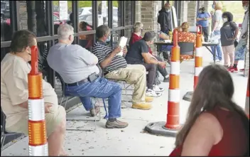  ?? ASSOCIATED PRESS ?? In this July 15 file photo, job seekers exercise social distancing as they wait to be called into the Heartland Workforce Solutions office in Omaha, Neb.