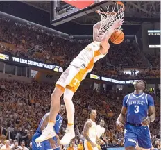  ?? ?? Tennessee guard Dalton Knecht, top left, dunks past Kentucky guard Adou Thiero, center on March 9 ,during an NCAA college basketball game in Knoxville, Tenn. (AP photo/wade Payne)