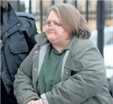  ?? DAVE CHIDLEY/THE CANADIAN PRESS ?? Elizabeth Wettlaufer is escorted into the courthouse in Woodstock, Ont. on Friday, Jan. 13, 2017. Newly released court documents show a former Ontario nurse accused of killing eight seniors in her care had been suspended from a long-term care home...