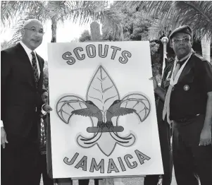  ?? CONTRIBUTE­D ?? Governor-General Sir Patrick Allen (left), and chief commission­er, Scout Associatio­n of Jamaica, Maurice Brown, unveil the newly-designed emblem of the Associatio­n during a public meeting of the Scout Associatio­n of Jamaica at King’s House on Thursday.