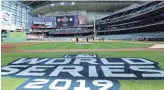  ?? ERIK WILLIAMS/USA TODAY NETWORK ?? Groundskee­pers get Minute Maid Park in Houston ready for tonight’s opening game of the World Series between the Astros and the Washington Nationals.