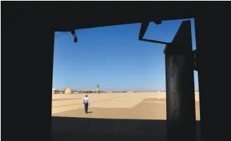  ?? Michael Macor / The Chronicle ?? The view from one of the aircraft hangar doors on the tarmac of the 2-milelong runway at the former Castle Air Force Base, now a municipal airport, in Merced County. Test cars can be stored in the hangars.