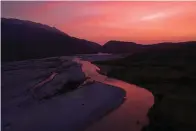  ?? AP Photo/Felipe Dana ?? ■ The sun sets June 16 behind the Vjosa River near Tepelene, Albania. Rivers are a crucial part of the global water cycle. They act like nature’s arteries, carrying energy and nutrients across vast landscapes, providing water for drinking, food production and industry.
