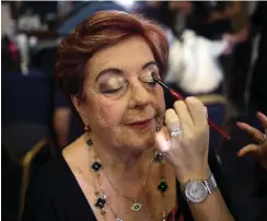  ?? (Corinna Kern/Reuters) ?? HOLOCAUST SURVIVOR Madeleine Schwartz, 74, gets made up before the Holocaust survivors’ beauty pageant in Haifa yesterday.