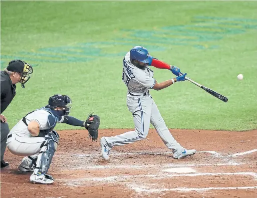  ?? MIKE CARLSON MLB PHOTOS/GETTY IMAGES ?? Blue Jays outfielder Teoscar Hernandez hits a sacrifice fly during Friday’s 6-4 win over the Tampa Bay Rays in St. Petersburg, Fla.