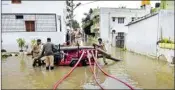  ?? PTI ?? Fire brigade personnel pump water from a flooded street after heavy rain, at Horamavu area in Bengaluru, on Thursday