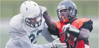  ??  ?? Jack Zittlau, left, of the Belle River Nobles tackles Ahl Djinko of the L’Essor Aigles during their WECSSAA AA championsh­ip game on Thursday. L’Essor racked up 532 yards rushing in a 42-7 win for the title.