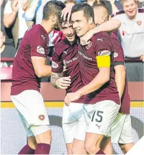  ??  ?? ■ Hearts’ Jamie Walker (centre) celebrates.