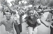  ?? Associated Press ?? n Supporters of opposition leader Raila Odinga celebrate Friday in Uhuru Park after hearing the verdict in Nairobi, Kenya. Kenya’s Supreme Court on Friday nullified President Uhuru Kenyatta’s election win last month and called for new elections within...