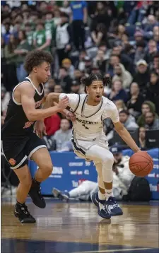  ?? PHOTO BY AMANDA SABGA — MEDIANEWS GROUP/BOSTON HERALD ?? Lawrence’s Danny Reyes, right, pushes away Newton North’s Dillon Taylor during a state tournament boys basketball clash. Visiting Newton North pulled out a 55-44 victory in Lawrence.