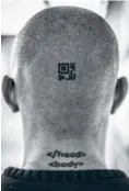  ??  ?? Sepúlveda’s head. The upper tattoo is a QR code containing an encryption key