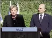  ?? ?? German Chancellor Angela Merkel (L) is flanked by Israeli PM Naftali Bennett (R) as she speaks outside the Yad Vashem Holocaust Museum in Jerusalem on Sunday