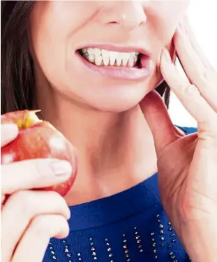  ??  ?? a common symptom of teeth sensitivit­y is a sudden, sharp pain when teeth are exposed to stimulants such as air, cold, sweet, acidic or hot foods.