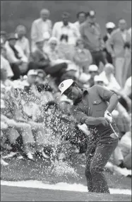  ?? AP FILE ?? FILE - Lee Elder hits the ball from a sand trap on the 18th hole at the Augusta National Golf Club course in Augusta, Ga., on April 10, 1975. Elder is the first black golfer to play in the Masters tournament.