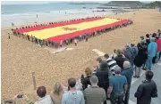  ?? /AFP ?? Separatist forces: Spanish far-right wing party Vox supporters unfold a giant Spanish flag ahead of the November 10 poll.