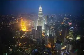  ?? BLOOMBERG PIC ?? According to Bank Julius Baer &amp; Co’s annual Wealth Report Asia, Kuala Lumpur is the best place to pick up a piano, indulge in cigars or book a hotel suite.