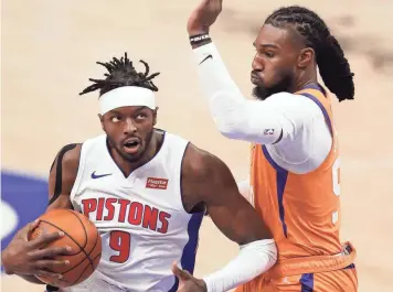  ?? PHOTOS BY RAJ MEHTA/USA TODAY SPORTS ?? Pistons forward Jerami Grant (9) drives to the basket against Suns forward Jae Crowder during the first quarter at Little Caesars Arena in Detroit on Friday night.