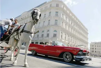  ?? — Reuters ?? A horse carriage waits for tourists outside the Gran Hotel Manzana, owned by the Cuban government and managed by Swiss-based Kempinski Hotels SA, in Havana.