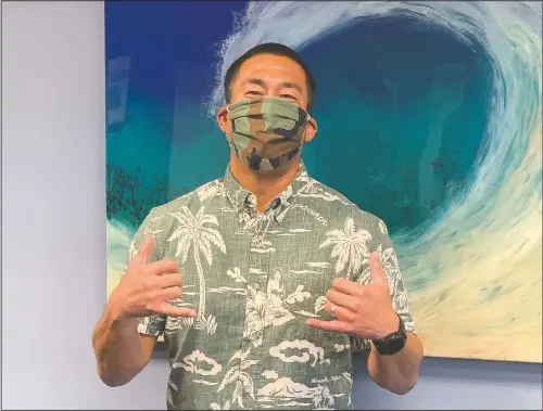  ?? (Kauai County via AP/Sarah Blane) ?? Kauai, Hawaii, Mayor Derek Kawakami wears a mask April 20 in Lihue, Hawaii. Kawakami has imposed a curfew to curb the spread of the coronaviru­s and now entertains residents with nightly videos to “break the boredom.”