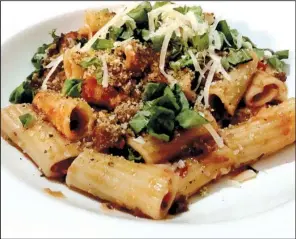  ?? Arkansas Democrat-Gazette/ERIC E. HARRISON ?? Ciao Baci’s Beef Bolognese features firm, plump rigatoni topped with a red-wine-tomato-meat sauce, grated parmesan, basil and bread crumbs.