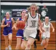  ?? RANDY MEYERS — FOR THE MORNING JOURNAL ?? Annika Bredel of Elyria Catholic leads a fast break during the third quarter against Bay on Dec. 15.