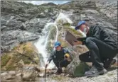  ?? ?? From top: Team members conduct scientific expedition work in the source area of the Yangtze River; Fan Yue (right) and Dong Shiqi conduct water quality testing at the outlet of a karst cave in the source area of the Lancang River.