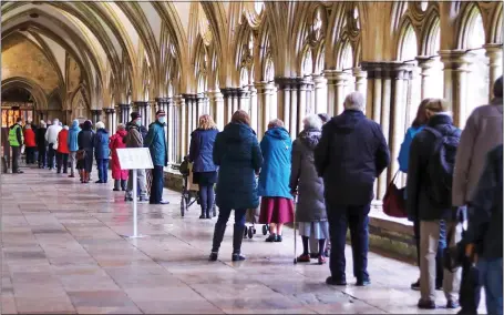  ??  ?? CLOISTERED: Salisbury’s over-80s, most of whom have been keeping safe indoors, queue for the jab at the cathedral yesterday