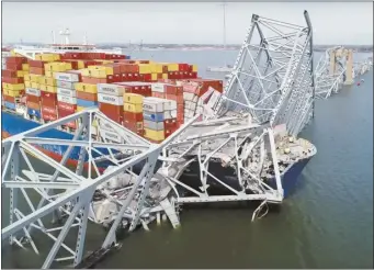  ?? NTSB image from video via AP ?? The cargo ship Dali is stuck under part of the structure of the Francis Scott Key Bridge after the ship hit the bridge on Tuesday, in Baltimore.