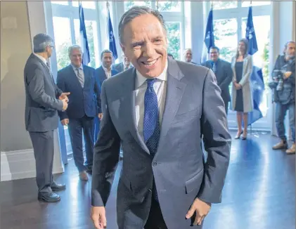 ?? CP PHOTO ?? Quebec Premier-designate Francois Legault leaves after speaking to the media the day after after winning the provincial election Tuesday.