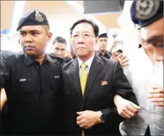  ?? MOHD RASFAN/AFP ?? Expelled North Korean ambassador to Malaysia Kang Chol (centre) is escorted by police in Kuala Lumpur’s airport yesterday.