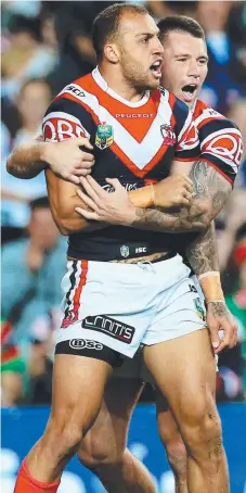  ?? Picture: MARK EVANS ?? DINING OUT: Blake Ferguson is embraced by Shaun Kenny-Dowall after scoring in the 30-0 win against Souths.