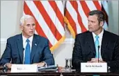  ?? ANDREW HARNIK/AP ?? Vice President Mike Pence, left, with Kansas Secretary of State Kris Kobach, speaks at a July commission meeting.