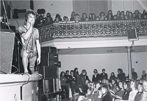  ??  ?? A STARMAN IS BORN: Singer David Bowie onstage at the Music Hall as his alter ego Ziggy Stardust in 1973