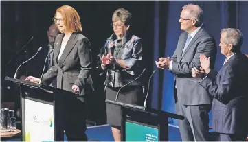  ??  ?? Australia’s former prime minister Julia Gillard (left), who started the Royal Commission into institutio­nal child sexual abuse, is applauded by Morrison (second right) and opposition Labour leader Bill Shorten (right), as she addresses the public in the Parliament House in Canberra. — AFP photo