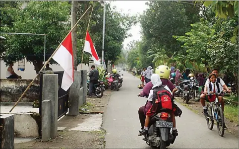  ?? BOY SLAMET/JAWA POS ?? BERKABUNG: Bendera Merah Putih setengah tiang dipasang di halaman SDN Jimbaran Wetan dan rumah warga sekitar sekolah kemarin.